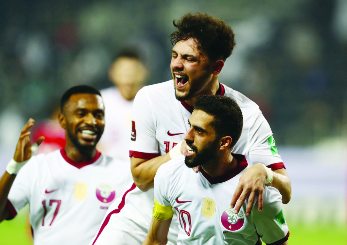 Qatar’s Hassan Al Haydos celebrates with team-mates after against Oman on Monday.