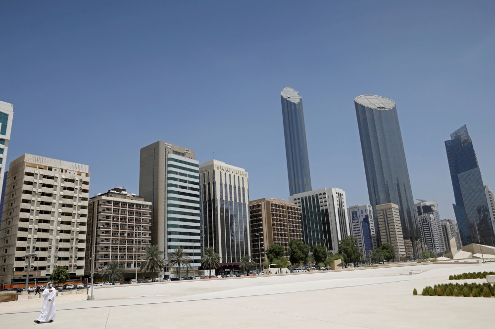 FILE PHOTO: An Emirati man wears a protective mask as he walks past buildings in Abu Dhabi, United Arab Emirates September 1, 2020. REUTERS/Nir Elias