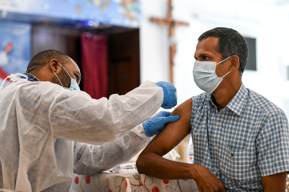 A man receives a dose of a vaccine against the coronavirus disease (COVID-19) at St. Paul's Church in Abu Dhabi, United Arab Emirates January 16, 2021. REUTERS/Khushnum Bhandari/File Photo