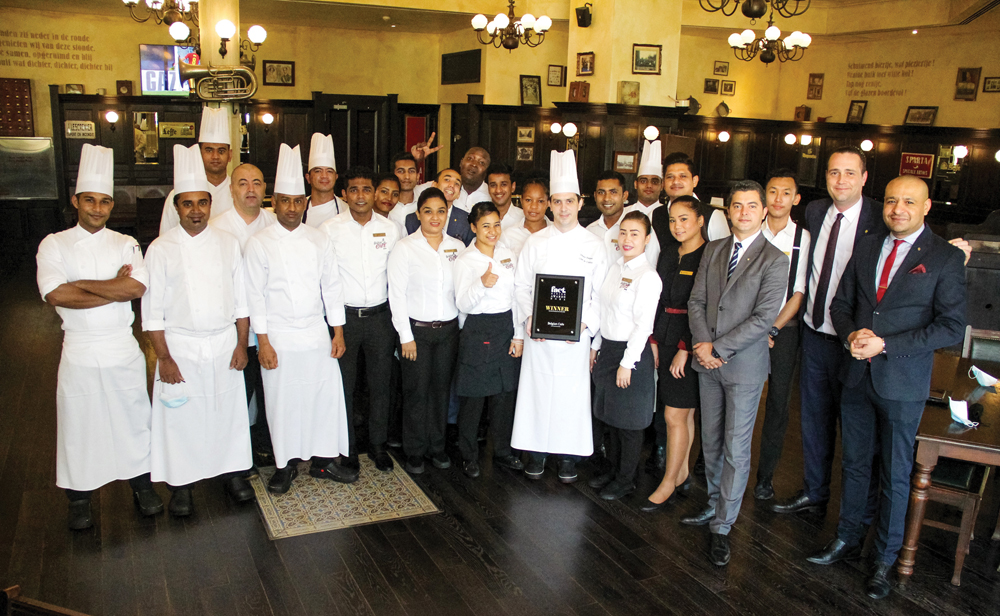 InterContinental Doha staff displaying one of the awards.