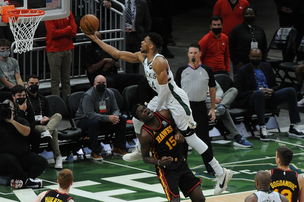 Milwaukee Bucks forward Giannis Antetokounmpo (34) drives to the basket against Atlanta Hawks center Clint Capela (15) n the third quarter during game two of the Eastern Conference Finals for the 2021 NBA Playoffs at Fiserv Forum. Michael McLoone