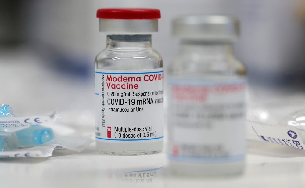 FILE PHOTO: A vial of the Moderna COVID-19 vaccine is seen at a clinic in Aschaffenburg, Germany, January 15, 2021. REUTERS/Kai Pfaffenbach