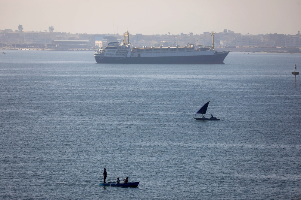 FILE PHOTO: A ship is seen after passing through the Suez Canal in Ismailia, Egypt March 25, 2021. REUTERS/Amr Abdallah Dalsh