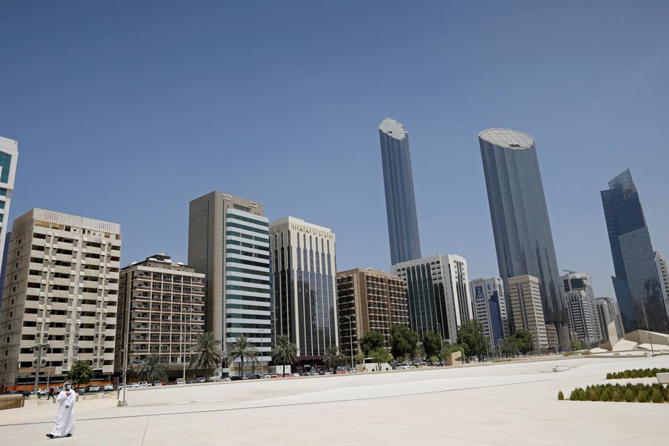 FILE PHOTO:An Emirati man wears a protective mask as he walks past buildings in Abu Dhabi, United Arab Emirates September 1, 2020. REUTERS/Nir Elias/Pool/File Photo