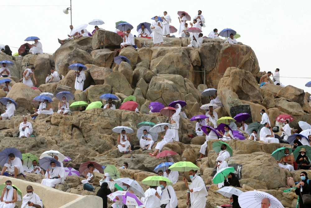 Pilgrims gather on Mount Mercy on the plains of Arafat during the annual Haj pilgrimage as the country barred worshippers from abroad for a second year running due to the coronavirus disease (COVID-19) pandemic, outside the holy city of Mecca, Saudi Arabi