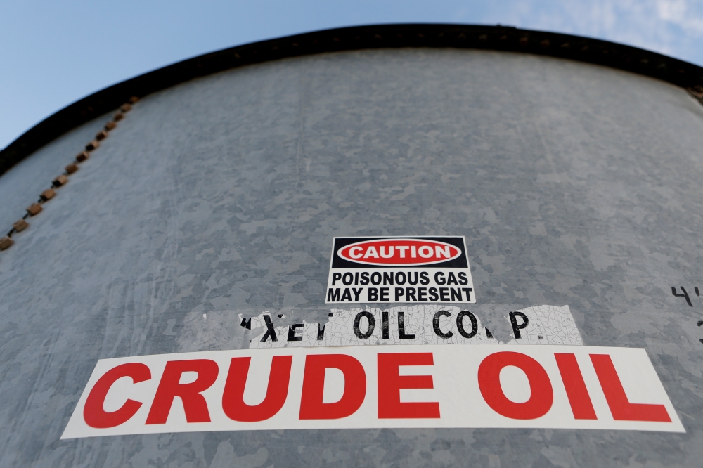 A sticker reads crude oil on the side of a storage tank in the Permian Basin in Mentone, Loving County, Texas, U.S. November 22, 2019. REUTERS/Angus Mordant/File Photo
 