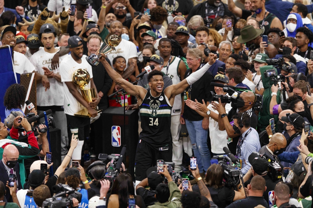 Milwaukee Bucks forward Giannis Antetokounmpo (34) celebrates with the NBA Finals MVP Trophy following the game against the Phoenix Suns following game six of the 2021 NBA Finals at Fiserv Forum. Jeff Hanisch