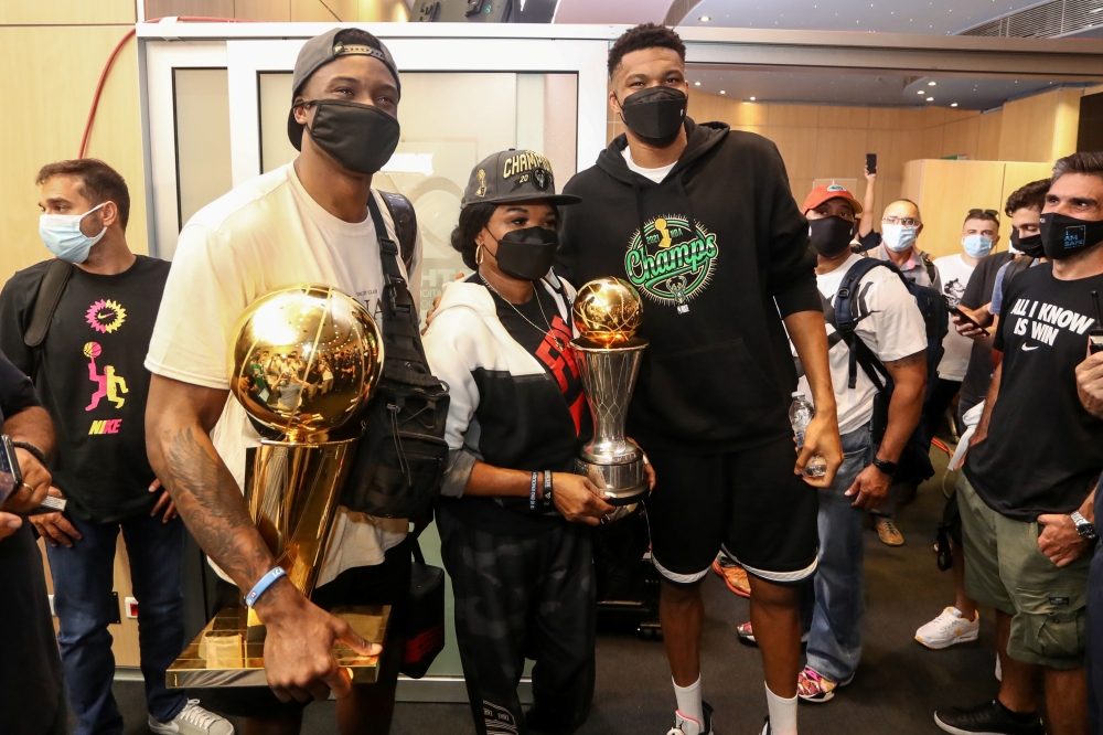 Milwaukee Bucks forward Giannis Antetokounmpo, Milwaukee Bucks forward Thanasis Antetokounmpo and their mother Veronica Antetokounmpo pose for a picture as they arrive at the Eleftherios Venizelos International Airport in Athens, Greece, August 1, 2021. T