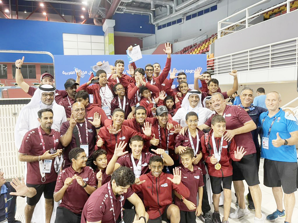 President of the Qatar Swimming Association, Khalil Al Jaber poses for a photograph with officials and the Qatari swimmers who won medals at the 28th GCC Aquatics Championship at the Hamad Aquatic Centre in Doha, yesterday. Qatar bagged an outstanding med