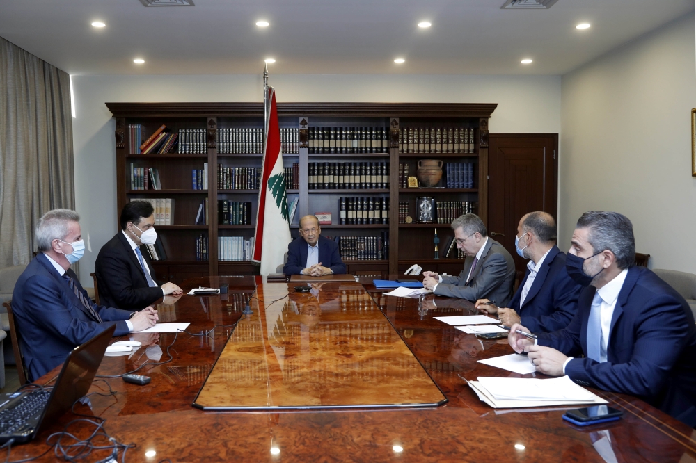 Lebanon's President Michel Aoun meets with Lebanon's caretaker Prime Minister Hassan Diab, Central Bank Governor Riad Salameh, and caretaker Finance Minister Ghazi Wazni at the presidential palace in Baabda, Lebanon August 21, 2021.

