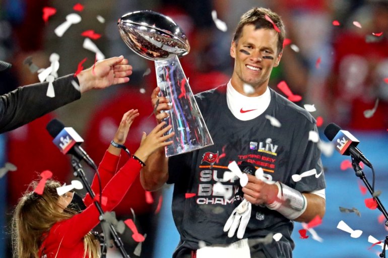 Tampa Bay Buccaneers quarterback Tom Brady (12) celebrates with the Vince Lombardi Trophy after beating the Kansas City Chiefs in Super Bowl LV at Raymond James Stadium. Mandatory Credit: Mark J. Rebilas-USA TODAY Sports