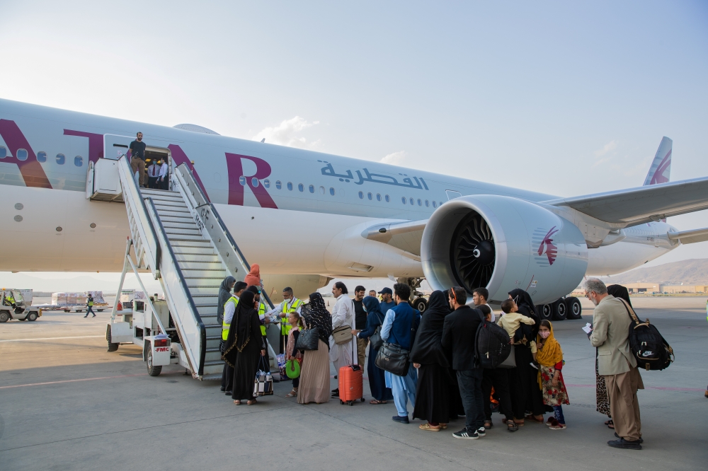 Afghan passengers are pictured in-front of a Qatar Airways airplane at Kabul International Airport, in Kabul, Afghanistan September 19, 2021. Qatar's Ministry of Foreign Affairs/Handout via REUTERS