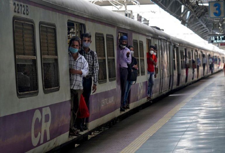 Commuters wearing protective face masks travel in a suburban train after authorities resumed the train services for all commuters after it was shut down to prevent the spread of the coronavirus disease (COVID-19), in Mumbai, India, February 1, 2021. REUTE