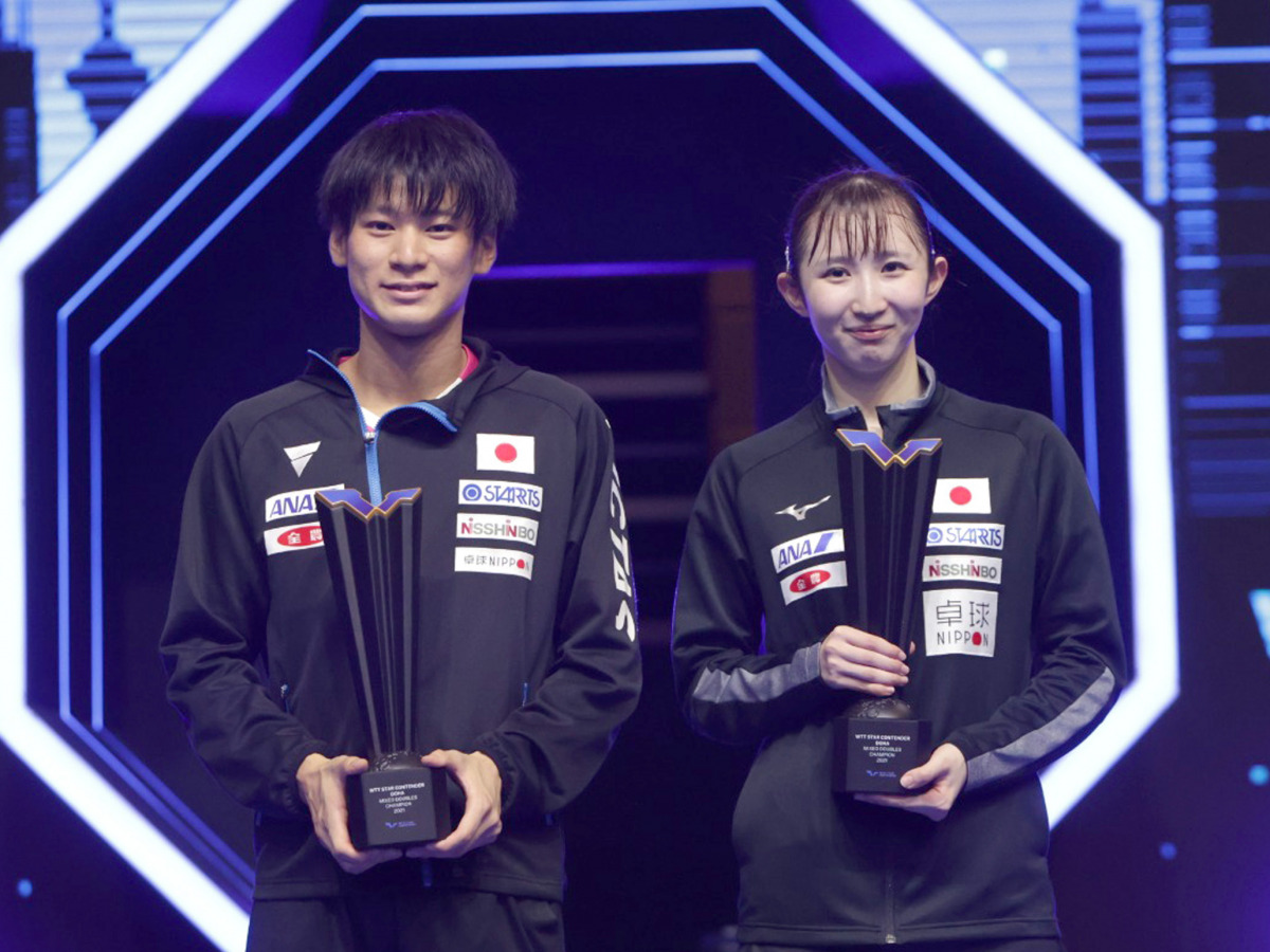 Japan's Shunsuke Togami and Hina Hayata pose with the champion's trophies after winning the mixed doubles title at the Lusail Sports Arena yesterday.