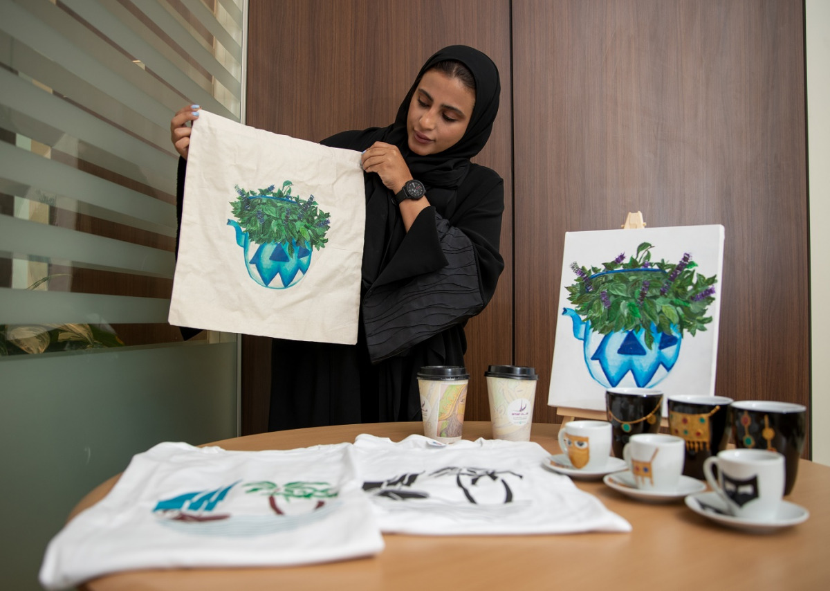 Sabika Ahmed Al Nasr showing some products available at the  Education City Gift Shop.