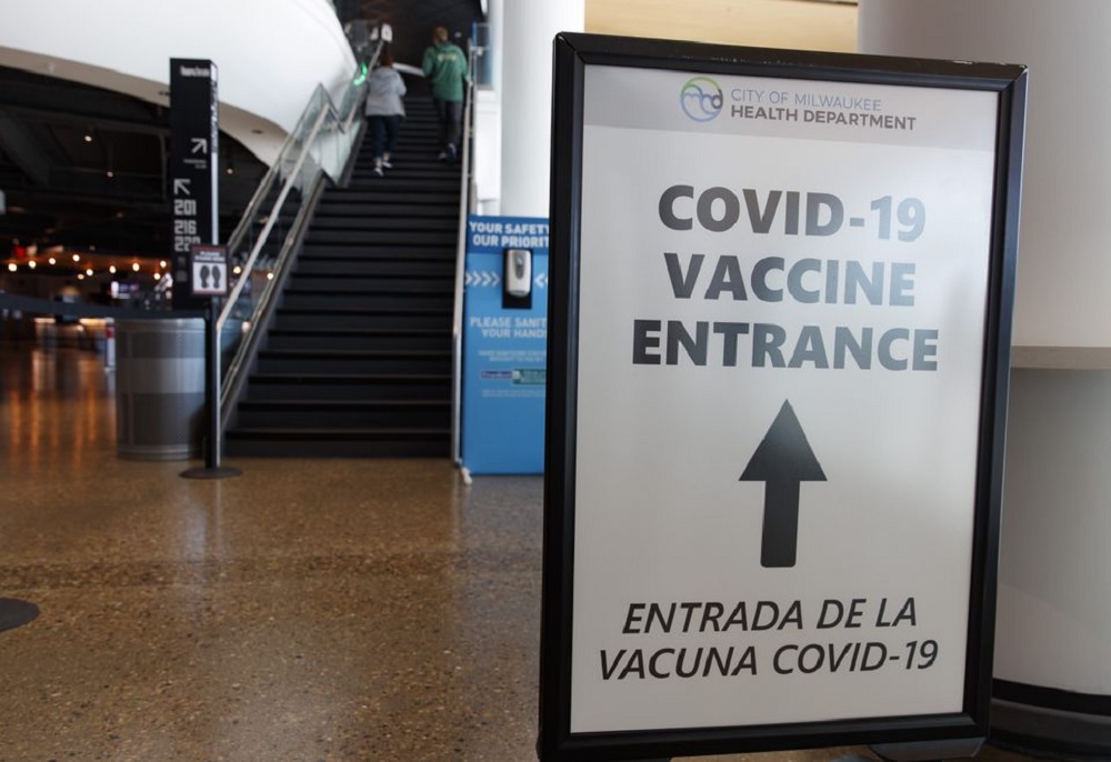 May 2, 2021; Milwaukee, Wisconsin, USA; A sign directing fans where to receive a COVID-19 vaccination prior to the game between the Milwaukee Bucks and the Brooklyn Netsat Fiserv Forum. /Jeff Hanisch-USA TODAY Sports/File Photo