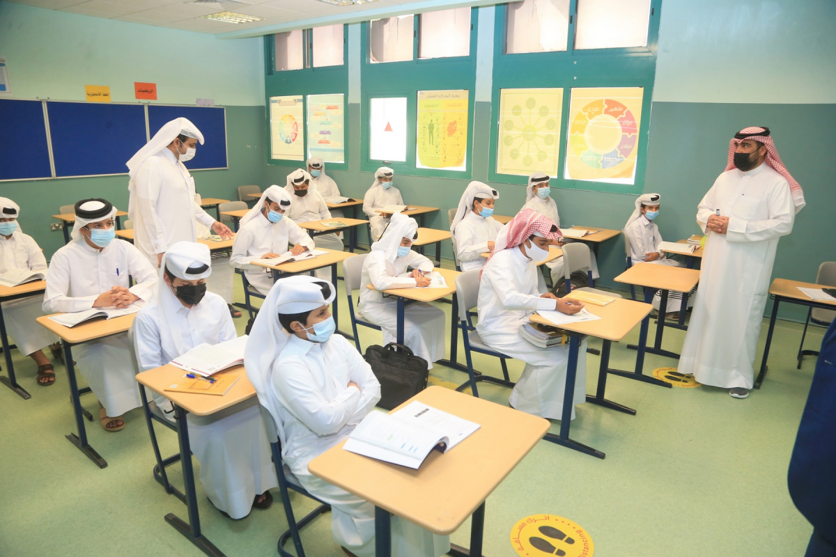 Teachers interacting with students in a classroom after the schools reopened for in-person classes.