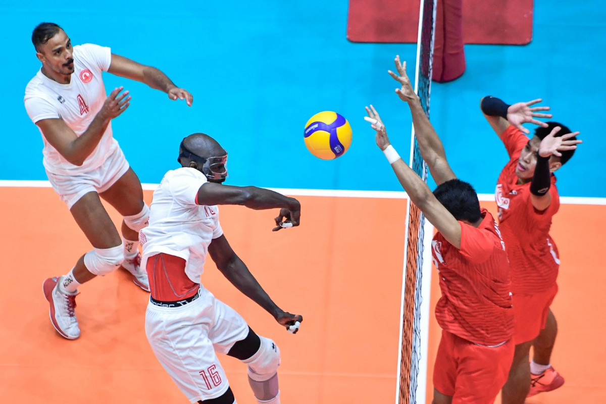 An Al Arabi player (left) smashes a shot during the match against Rebisco Philippines yesterday.  