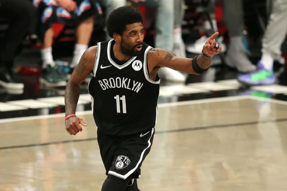 Brooklyn Nets point guard Kyrie Irving (11) reacts after making a basket against the Milwaukee Bucks during the second quarter of game one in the Eastern Conference semifinals of the 2021 NBA Playoffs at Barclays Center. Mandatory Credit: Brad Penner-USA 