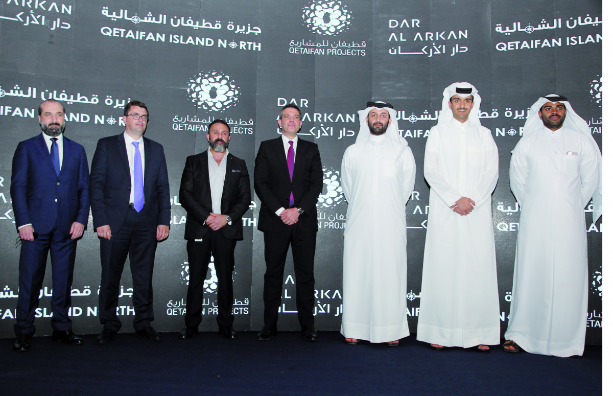 Sheikh Nasser bin Abdulrahman Al Thani (third right), Managing Director of Qetaifan Projects and Ziad El Chaar (fourth left), Vice Chairman of Dar Al Arkan Properties, and other officials during the MoU signing ceremony, on the sidelines of Cityscape Qata