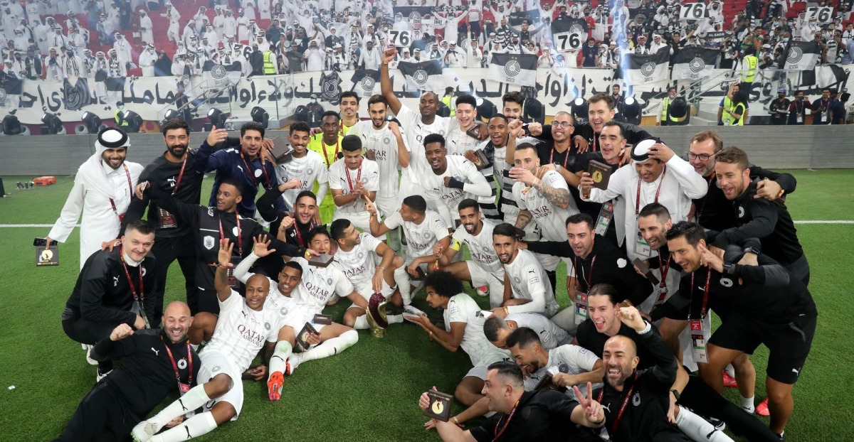 Al Sadd players and officials celebrate after winning the Amir Cup.