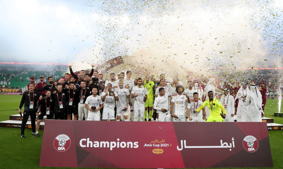 Al Sadd's players and officials celebrate with the Amir Cup trophy. Pic: Al Sadd