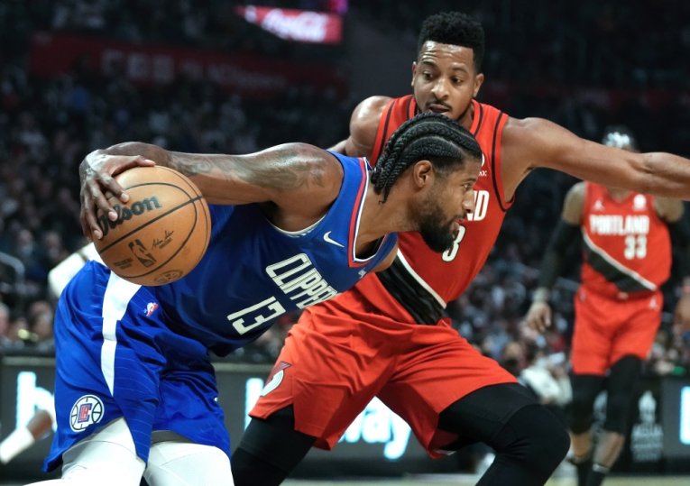 LA Clippers guard Paul George (13) tries to dribble the ball past Portland Trail Blazers guard CJ McCollum (3) in the seconds quarter at Staples Center. Robert Hanashiro