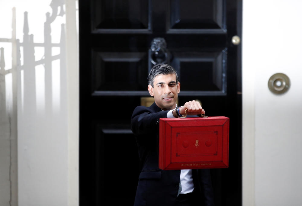 Britain's Chancellor of the Exchequer Rishi Sunak holds the budget box outside Downing Street in London, Britain, October 27, 2021. REUTERS/Peter Nicholls