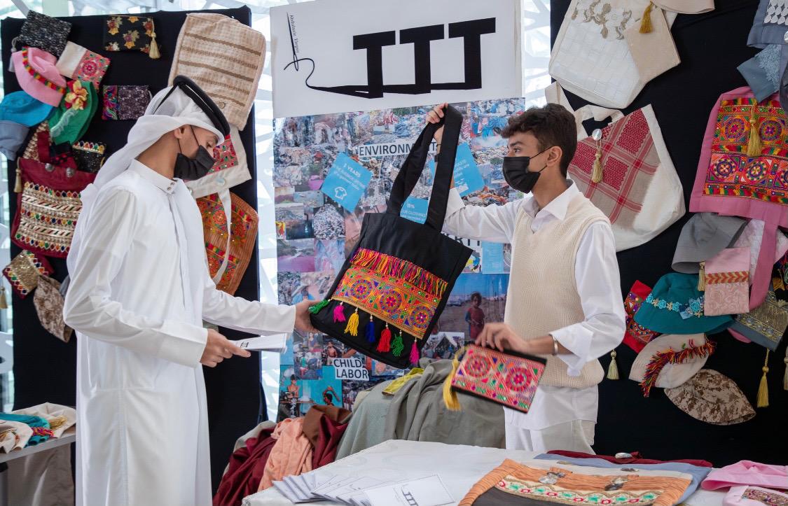 Grantee Abdulaziz Elepsy (right), a Grade 11 student at Qatar Academy Doha, exhibiting the products made from recycling old clothes at Education City Student Center.