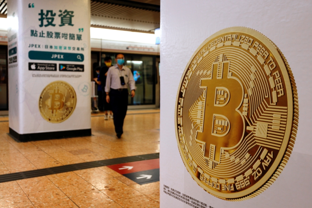 Advertisements for crypto exchange show a Bitcoin symbol at Mass Transit Railway (MTR) station, in Hong Kong, China. October 27, 2021. Reuters/Tyrone Siu/File Photo