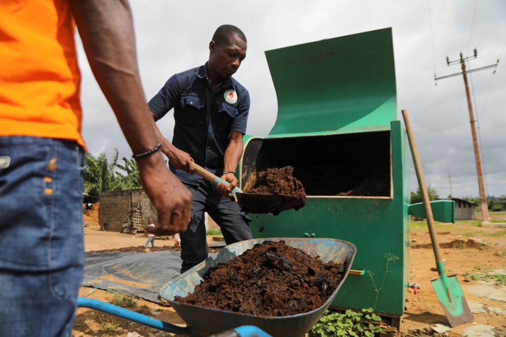 Agents remove organic fertilizer from an Award-winning biowaste converter Kubeko machine, in Nandibo, Ivory Coast October 19, 2021. Picture taken October 19, 2021. REUTERS/ Luc Gnago