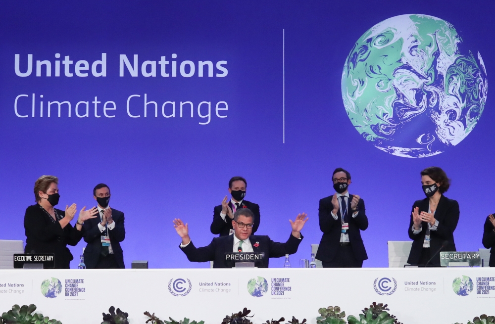 COP26 President Alok Sharma gestures as he receives applause during the UN Climate Change Conference (COP26) in Glasgow, Scotland, Britain November 13, 2021. REUTERS/Yves Herman