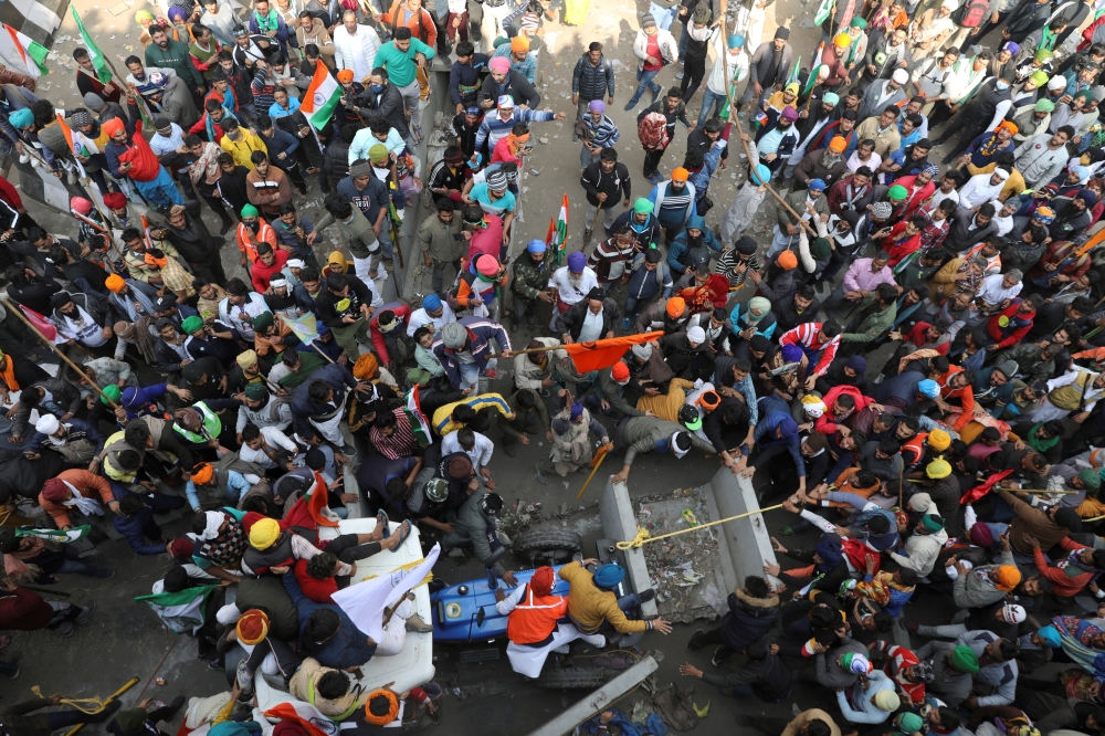 FILE PHOTO: Farmers and protesters pull a blockade using tractor during a tractor rally to protest against farm laws on the occasion of India's Republic Day at Tikri border near New Delhi, India, January 26, 2021. REUTERS/Anushree Fadnavis/File Photo