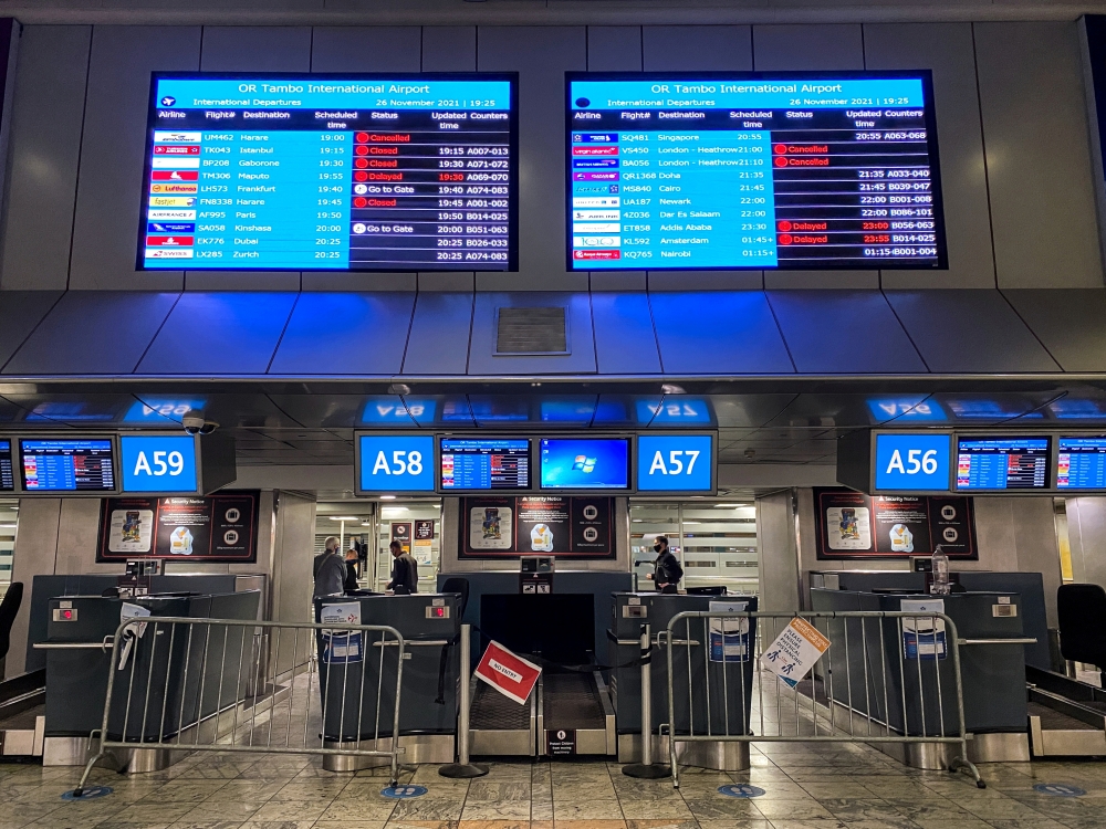 Digital display boards show cancelled flights to London - Heathrow at O.R. Tambo International Airport in Johannesburg, South Africa, November 26, 2021. REUTERS/ Sumaya Hisham/File Photo.