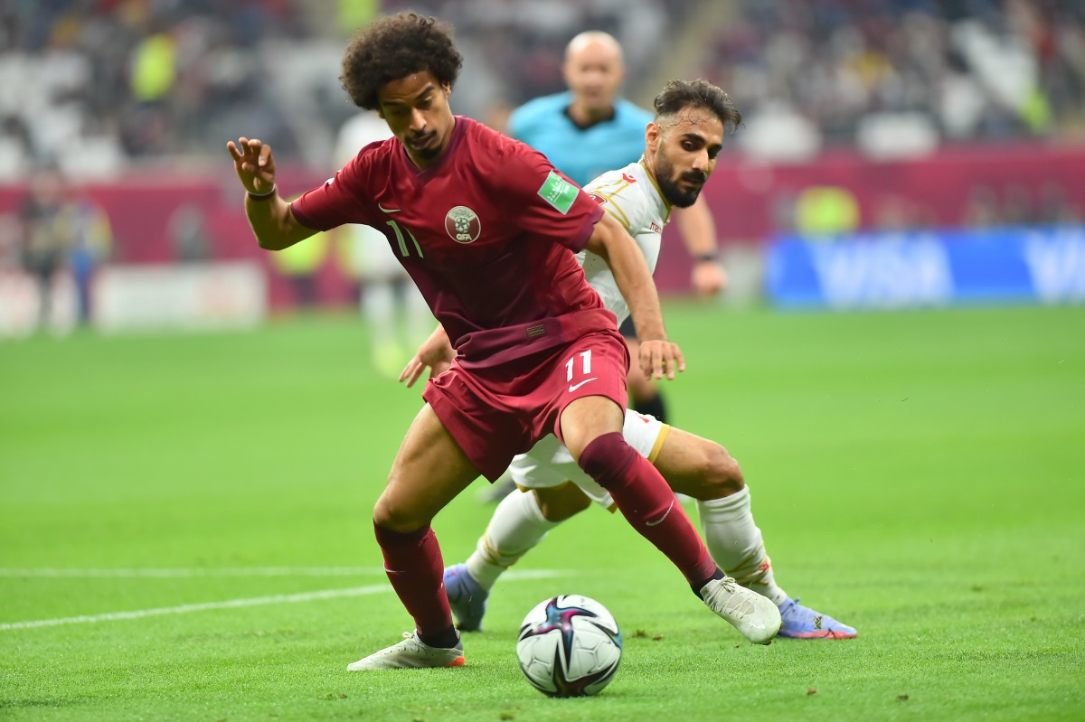 Qatar’s Akram Afif in action with a Bahraini player during their Group A match at Al Bayt Stadium on Tuesday. Picture: Abdul Basit / The Peninsula