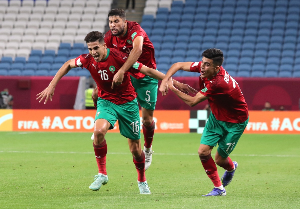 Morocco’s Mohamed Nahiri celebrates with Yahya Jabrane and Achraf Bencharki after scoring a goal against Palestine at Al Janoub Stadium, yesterday.