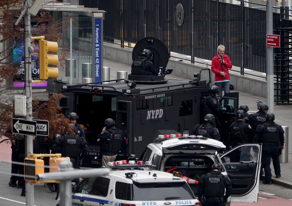 An armed man speaks with members of the NYPD outside the UNited Nations Headquarters in New York City, U.S., December 2, 2021. REUTERS/Carlo Allegri
