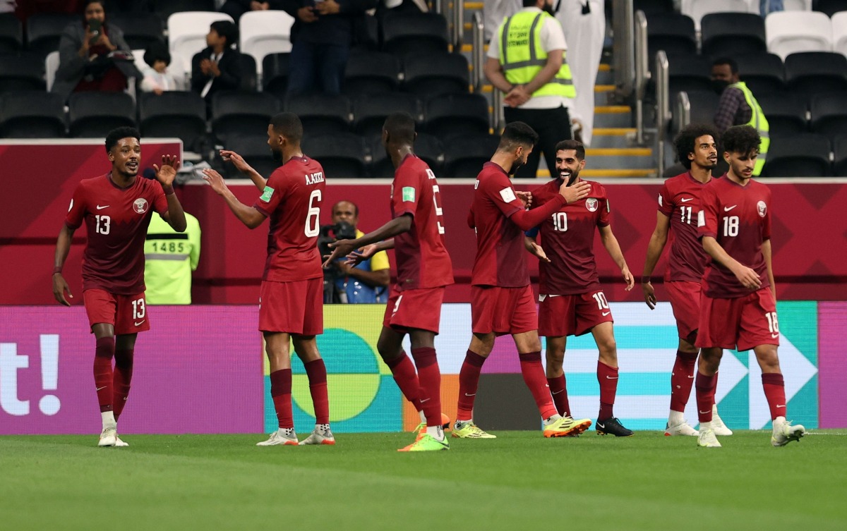 Hassan Al Haydos celebrates with teammates after scoring Qatar's third goal against Iraq on Monday.