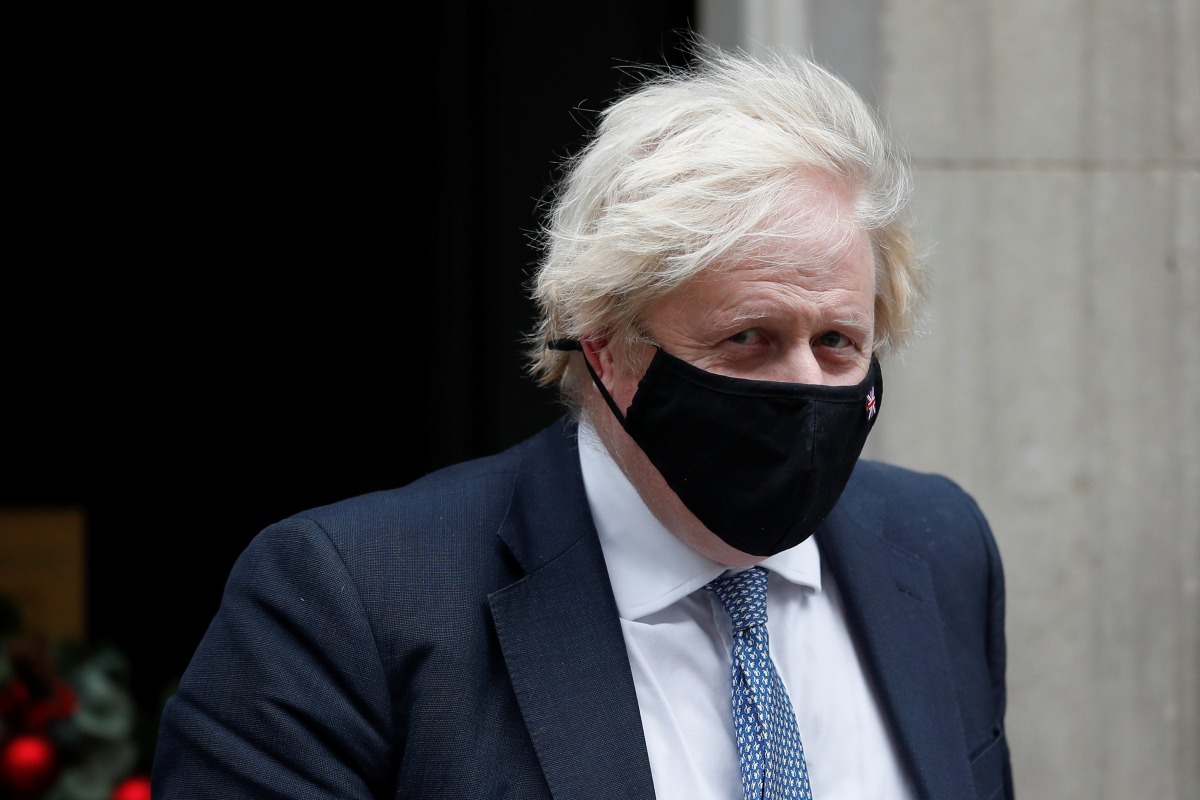 Britain's Prime Minister Boris Johnson walks outside Downing Street in London, Britain, December 8, 2021. REUTERS/Peter Nicholls
