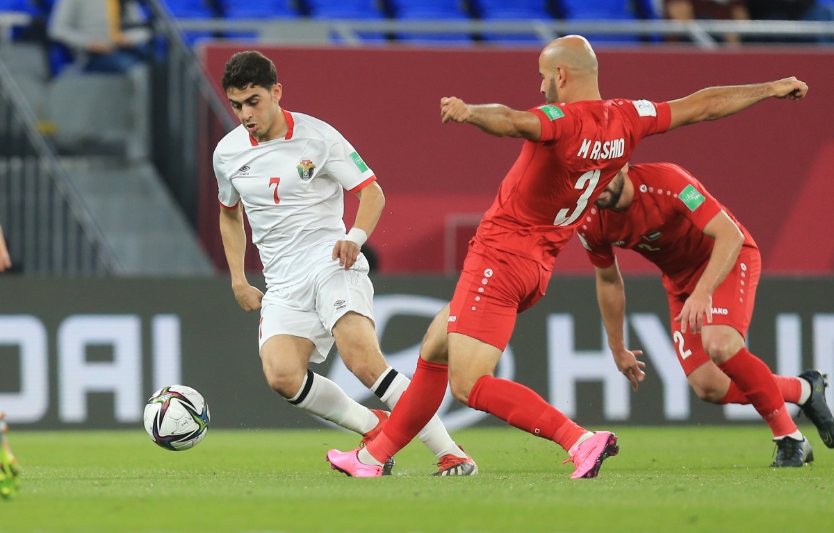 Jordan’s Mohamed Zraiq vies for the ball possession with Palestinian's Mohammed Rashid.