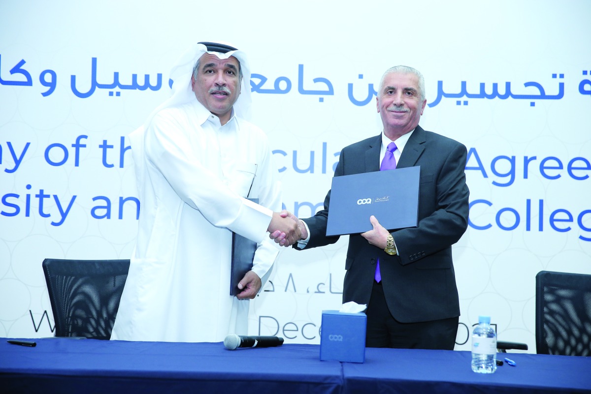 CCQ President Dr. Mohamed Ibrahim Al Naemi; Lusail University Provost, Professor Nitham Mohammed Hindi, shake hands after signing the agreement. 