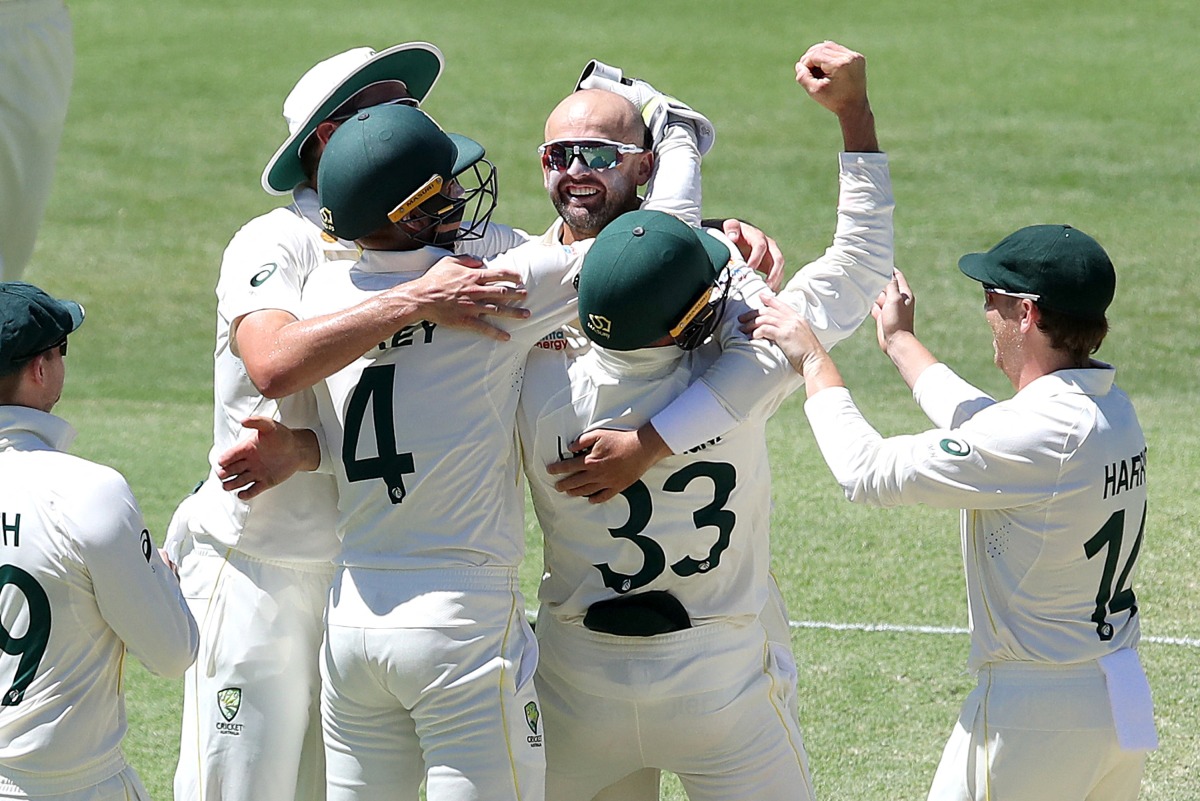 Australia's Nathan Lyon celebrates taking his 400th test wicket during day four of the First Ashes Test Jono Searle/AAP via REUTERS