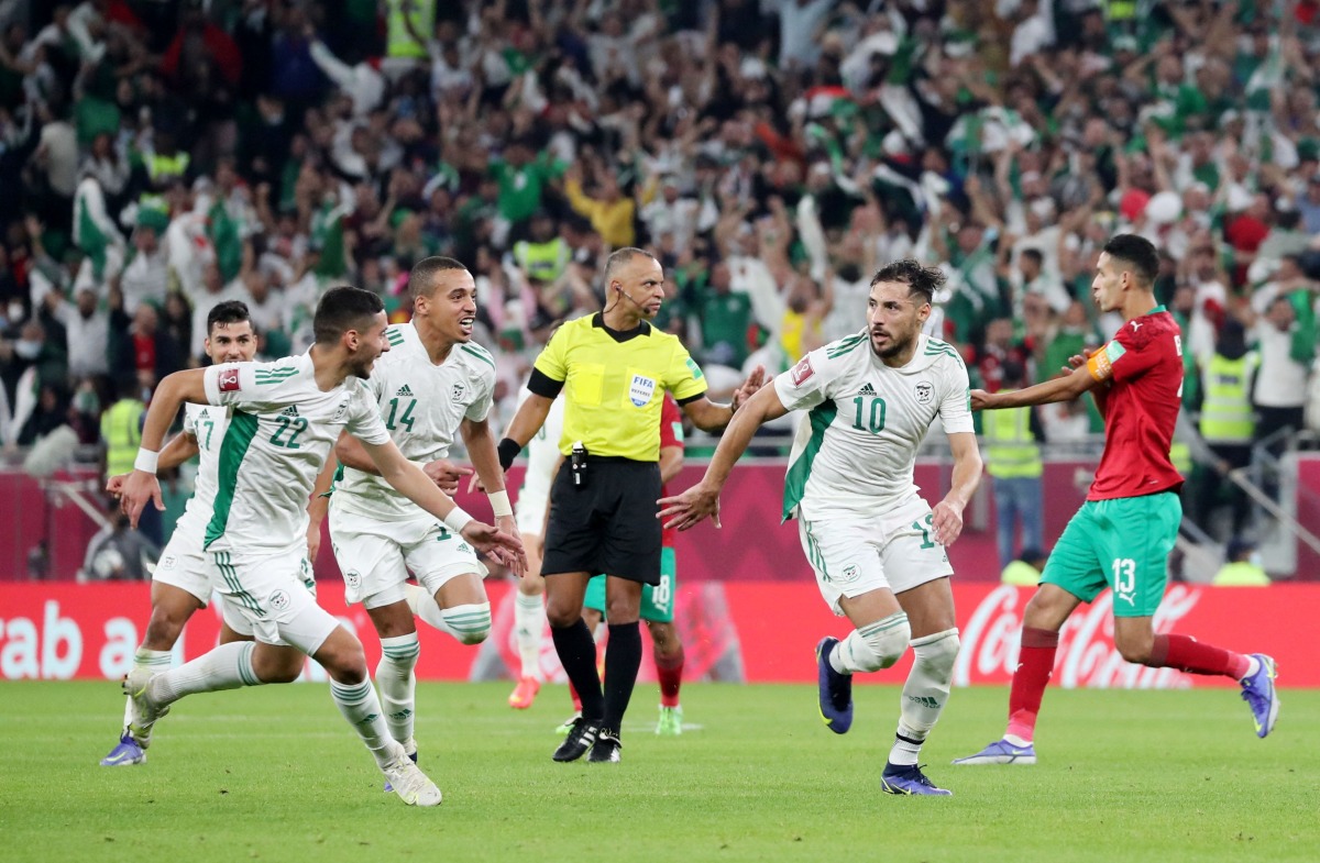  Algeria’s Mohammed Belaili (right) celebrates with team-mates after scoring their second goal.