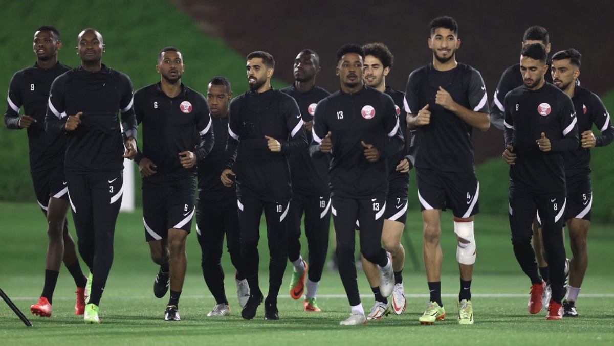 Qatar captain Hassan Al Haydos with team-mates during a training session, yesterday. 