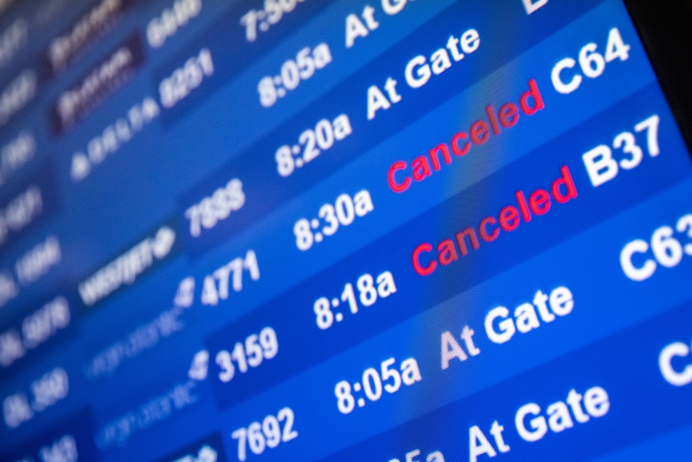 A screen showing cancelled flights is seen at John F. Kennedy International Airport during the spread of the Omicron coronavirus variant in Queens, New York City, U.S., December 26, 2021. REUTERS.