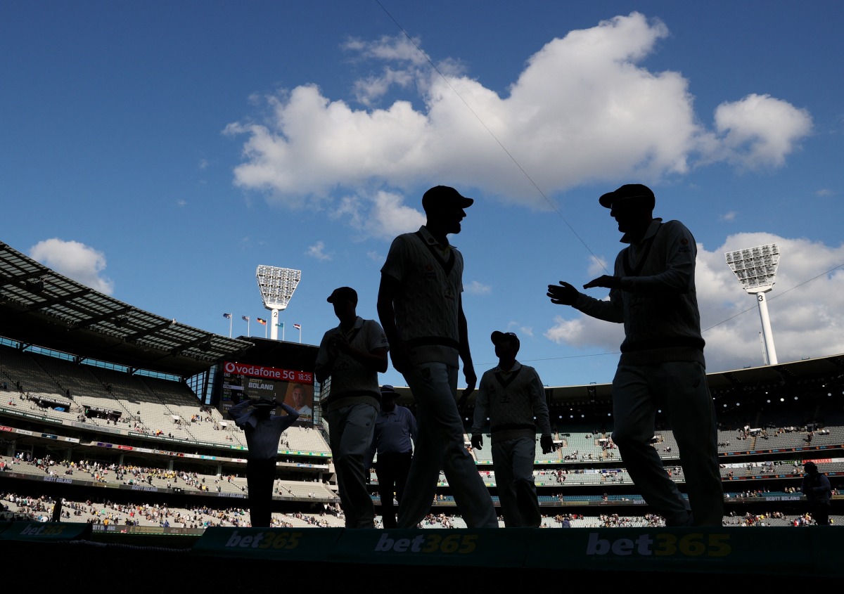 Australia players walk off the pitch after the end of the day REUTERS/Loren Elliott
