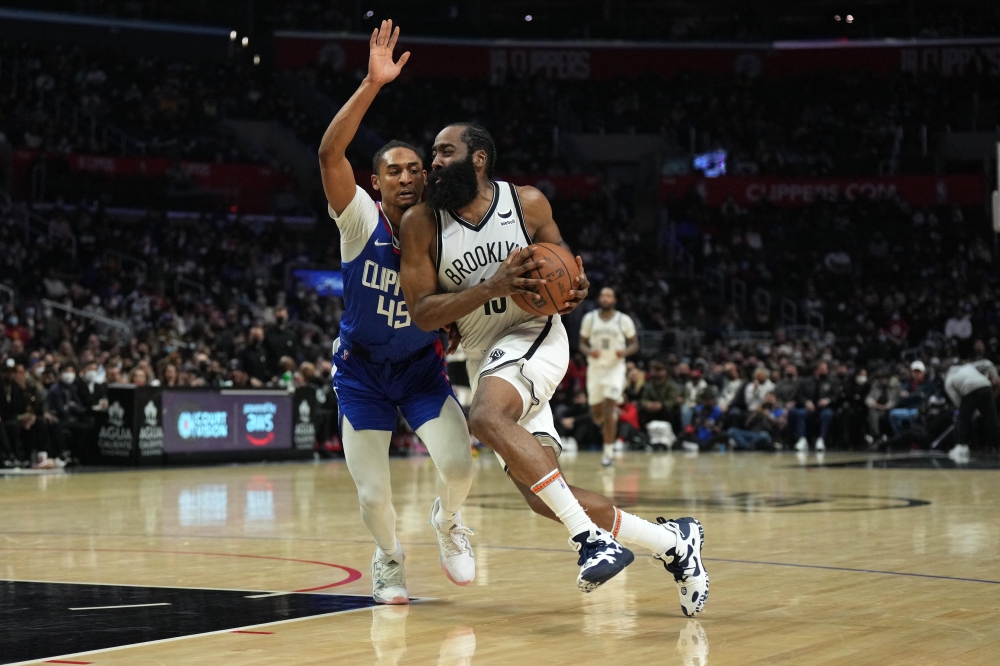 Los Angeles, California, USA; Brooklyn Nets guard James Harden (13) is defended by LA Clippers guard Keon Johnson (45) in the second half at Crypto.com Arena. Kirby Lee