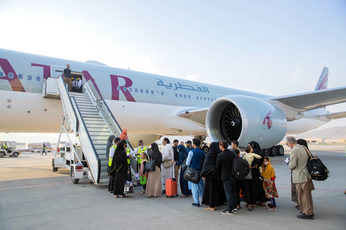 Afghan passengers board a Qatar Airways plane at Kabul International Airport, in Kabul, Afghanistan, on September 19, 2021. 