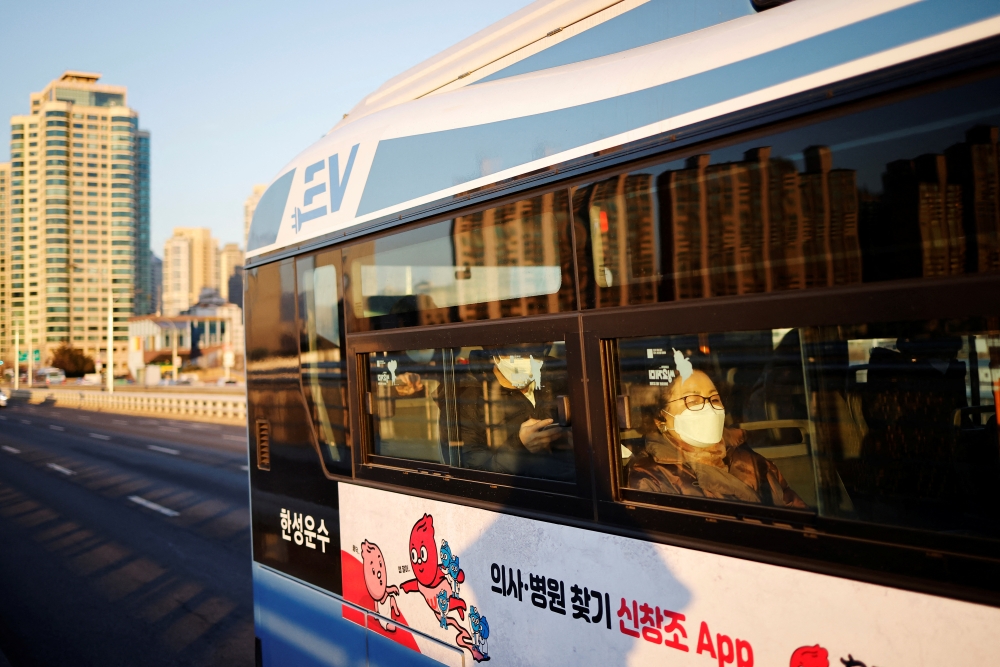 Passengers wearing masks to prevent contracting the coronavirus disease (COVID-19) sit inside a bus in Seoul, South Korea, January 4, 2022. REUTERS/Kim Hong-Ji