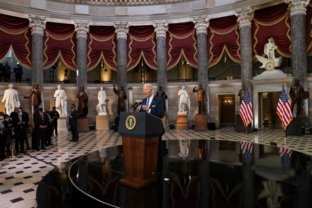 U.S. President Joe Biden speaks in Statuary Hall on the first anniversary of the January 6, 2021 attack on the U.S. Capitol by supporters of former President Donald Trump, on Capitol Hill in Washington, U.S., January 6, 2022. REUTERS.